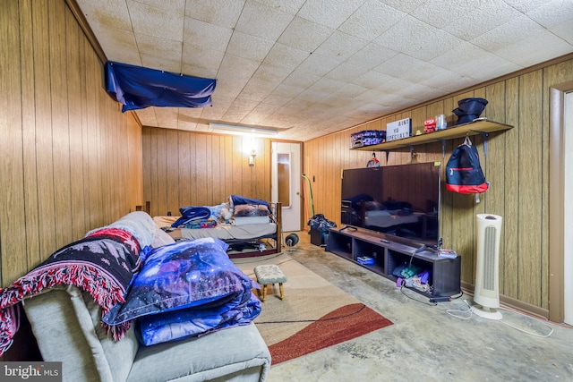 living area with wood walls and concrete flooring