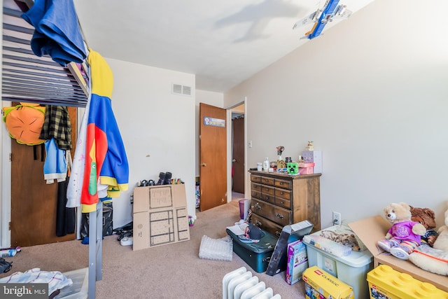 carpeted bedroom featuring visible vents