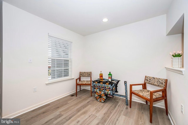 living area with wood finished floors and baseboards