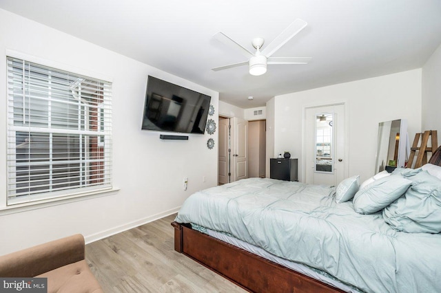 bedroom with visible vents, ceiling fan, baseboards, and wood finished floors