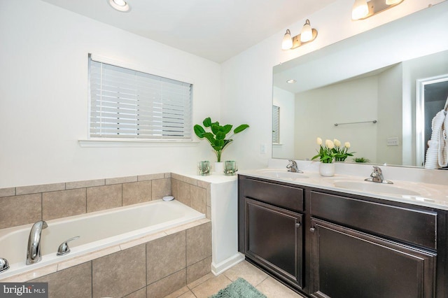 full bath featuring double vanity, a garden tub, a sink, and tile patterned floors