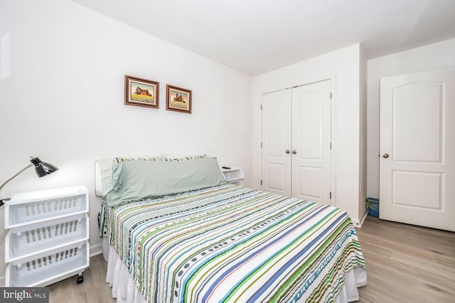 bedroom featuring a closet and wood finished floors