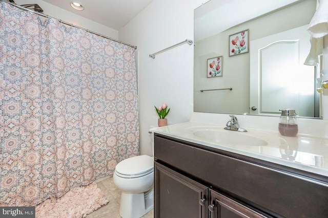 bathroom featuring tile patterned flooring, a shower with shower curtain, vanity, and toilet