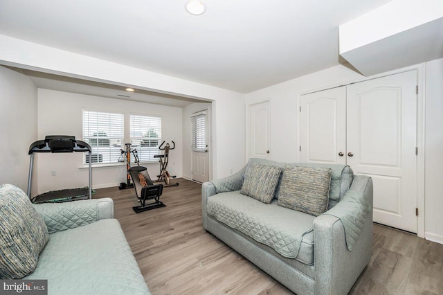 living room featuring light wood finished floors and baseboards