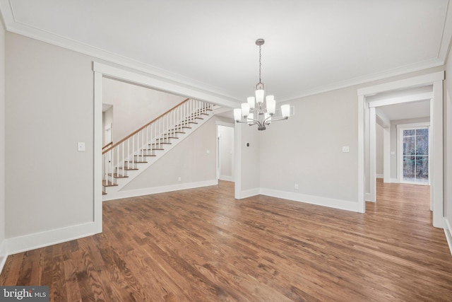 interior space with wood finished floors, stairway, an inviting chandelier, crown molding, and baseboards