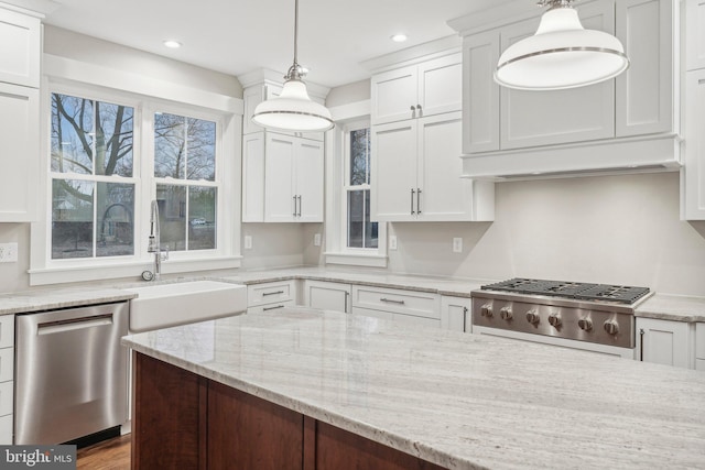 kitchen with pendant lighting, a sink, white cabinetry, light stone countertops, and dishwasher