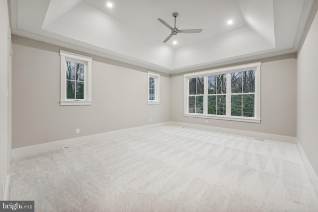 carpeted spare room featuring a tray ceiling, recessed lighting, baseboards, and ceiling fan