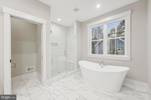 bathroom with a soaking tub, visible vents, marble finish floor, and a stall shower