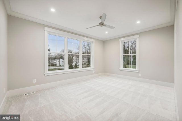 carpeted empty room featuring crown molding, recessed lighting, baseboards, and visible vents