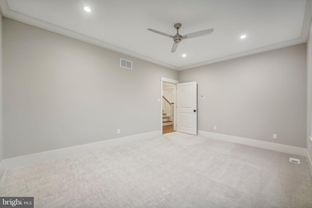 unfurnished room featuring light carpet, visible vents, baseboards, and ornamental molding