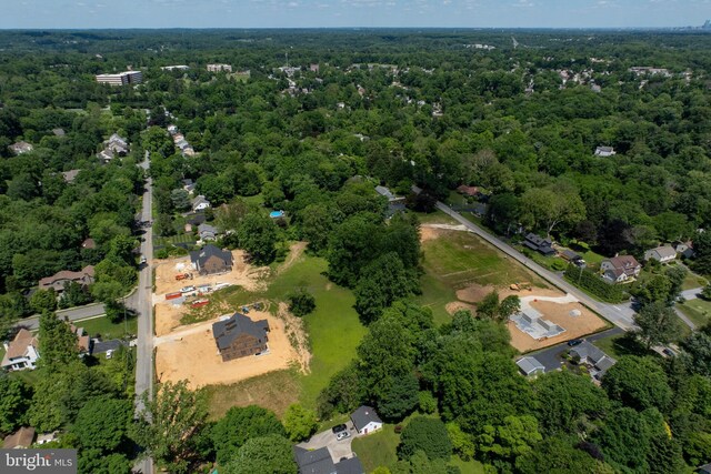 birds eye view of property featuring a view of trees