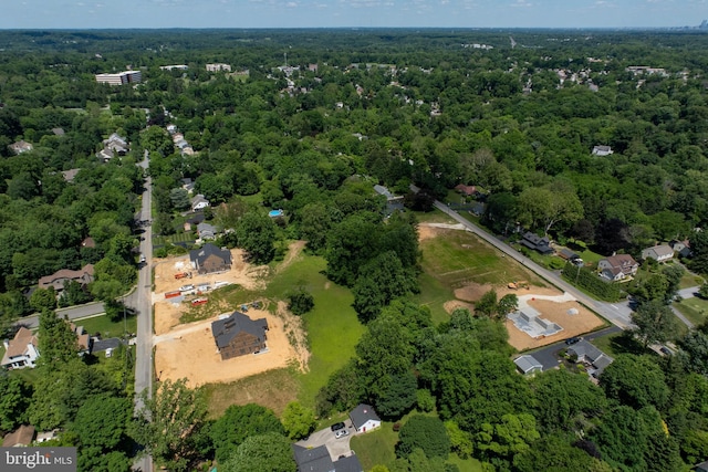 drone / aerial view featuring a wooded view