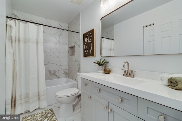 full bathroom featuring marble finish floor, vanity, shower / tub combo, and toilet