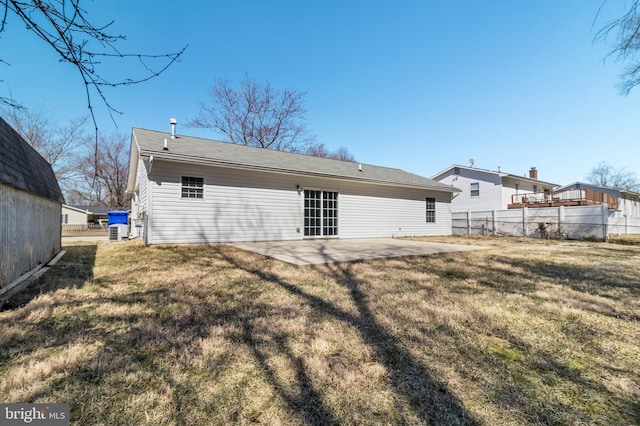 back of house featuring a yard, a patio area, and fence