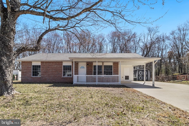 ranch-style house featuring concrete driveway, a porch, brick siding, and a front lawn