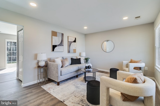 living area with visible vents, recessed lighting, baseboards, and wood finished floors