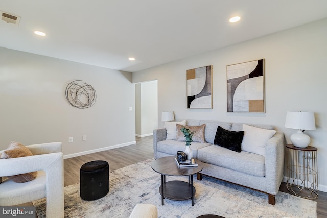 living area with visible vents, recessed lighting, baseboards, and wood finished floors