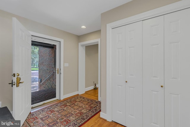 entrance foyer featuring light wood-type flooring and baseboards