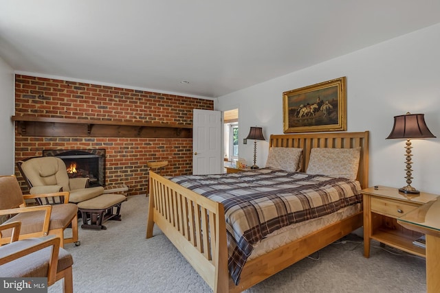 carpeted bedroom featuring a brick fireplace and brick wall