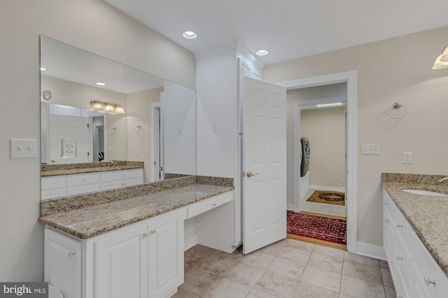 bathroom with recessed lighting, vanity, and baseboards