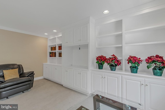 living area featuring built in shelves, recessed lighting, light colored carpet, ornamental molding, and baseboards