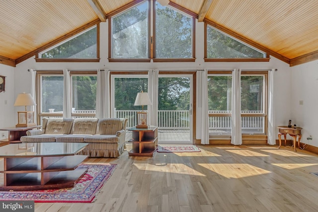 unfurnished sunroom featuring lofted ceiling, plenty of natural light, and wooden ceiling