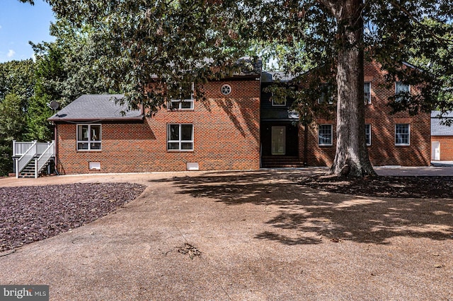 view of front of house with crawl space and brick siding