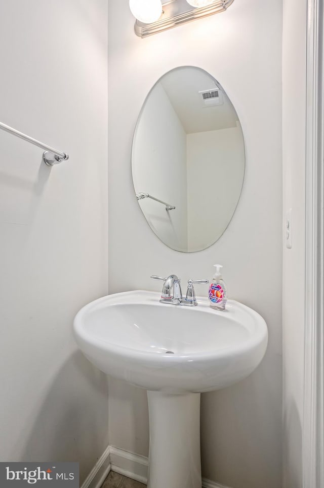bathroom with visible vents and a sink