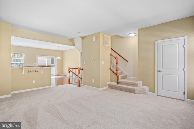 interior space featuring baseboards, carpet, and visible vents