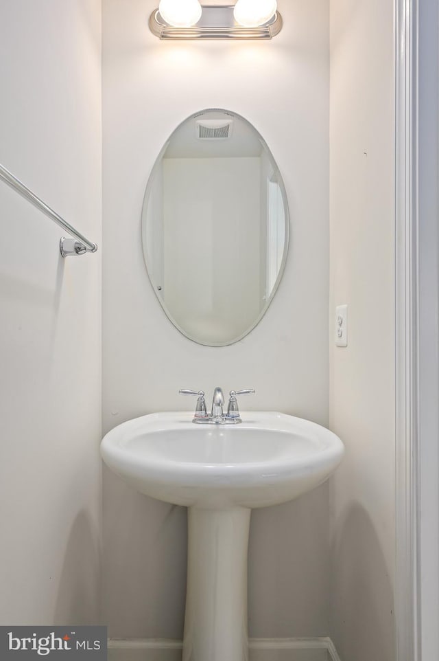 bathroom with visible vents and a sink