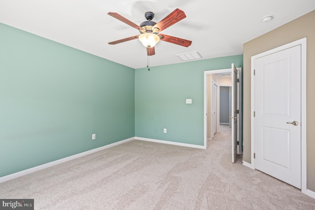 unfurnished bedroom with light colored carpet, baseboards, visible vents, and a ceiling fan