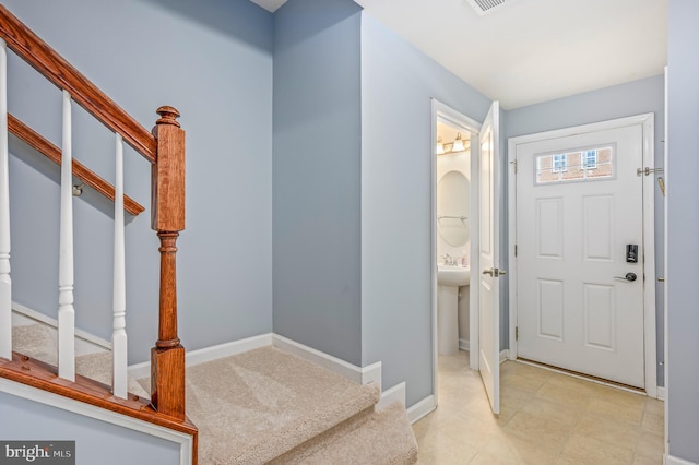 entrance foyer with baseboards and stairway