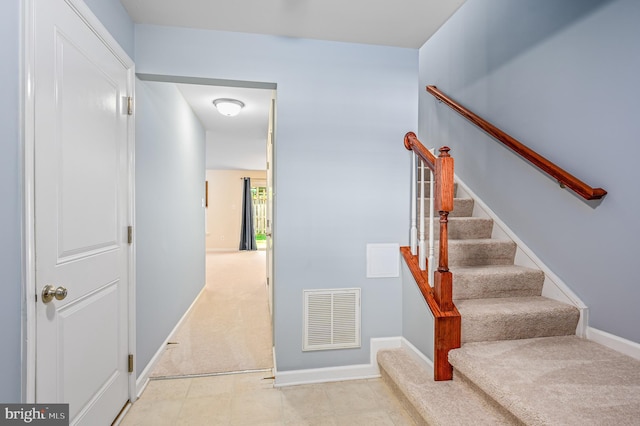 stairs with visible vents, carpet, and baseboards