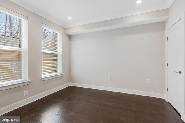 spare room with dark wood-type flooring, recessed lighting, crown molding, and baseboards