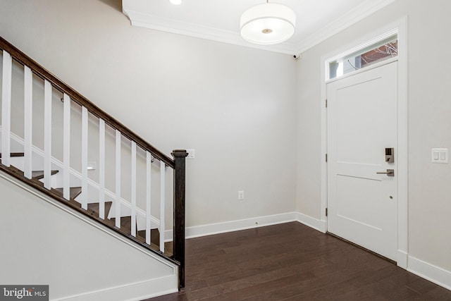 foyer with dark wood finished floors, stairway, crown molding, and baseboards