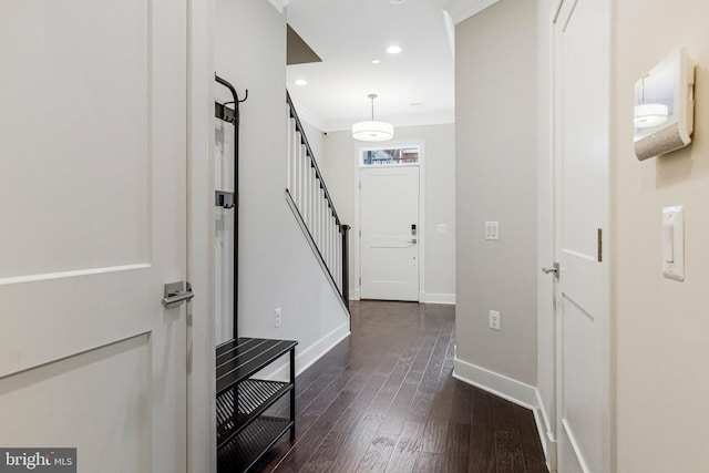 foyer with dark wood-style floors, baseboards, recessed lighting, stairs, and crown molding