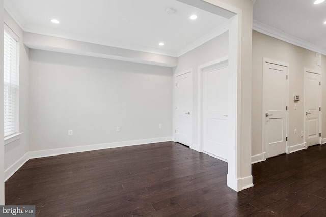 interior space featuring recessed lighting, baseboards, dark wood-type flooring, and crown molding