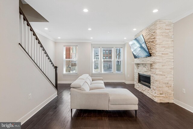 living area featuring stairs, crown molding, and dark wood-type flooring