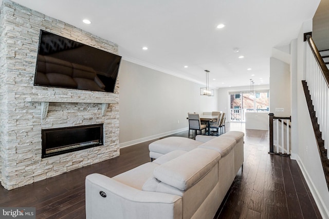 living room with baseboards, recessed lighting, ornamental molding, stairs, and wood-type flooring