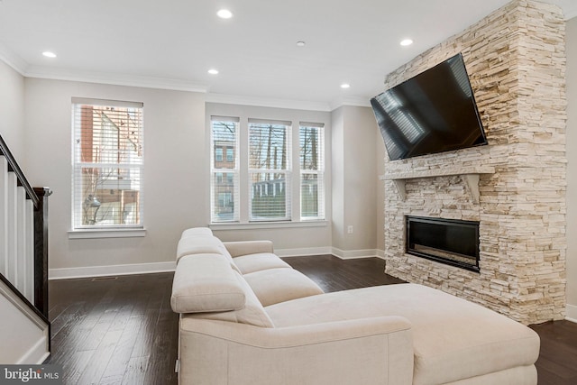 living area featuring crown molding, dark wood-style floors, and a healthy amount of sunlight