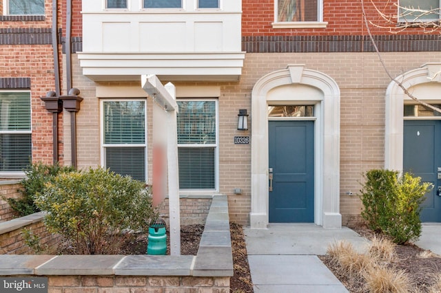 property entrance with brick siding