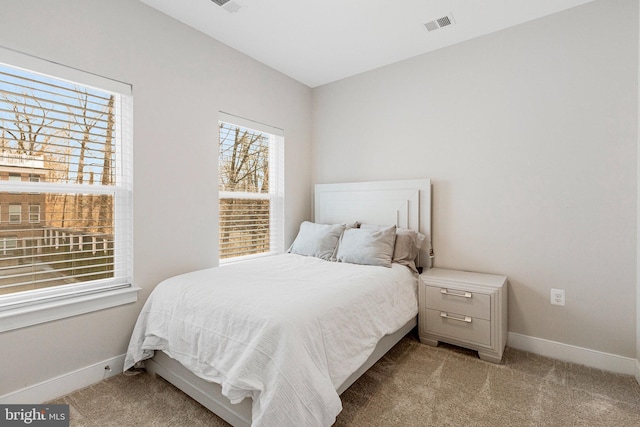 bedroom with baseboards and carpet