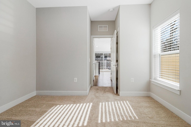 unfurnished bedroom with visible vents, carpet flooring, and baseboards