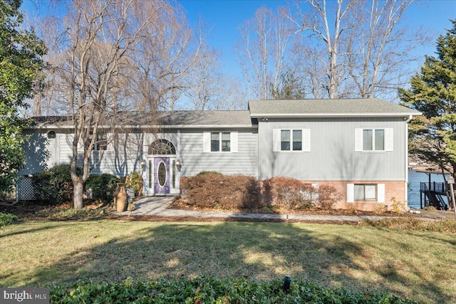 view of front of home with brick siding and a front yard