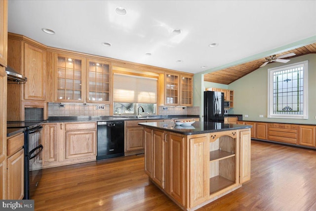 kitchen with decorative backsplash, a kitchen island, vaulted ceiling, black appliances, and open shelves