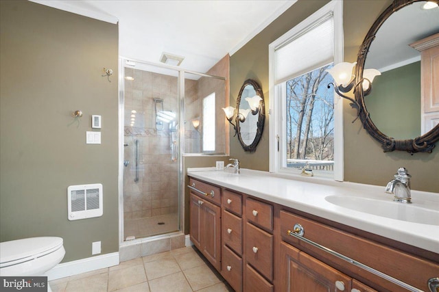 full bathroom with heating unit, toilet, a stall shower, a sink, and tile patterned floors