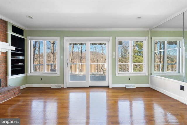 unfurnished sunroom featuring a wealth of natural light and visible vents