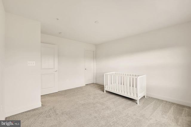 unfurnished bedroom with carpet floors and baseboards