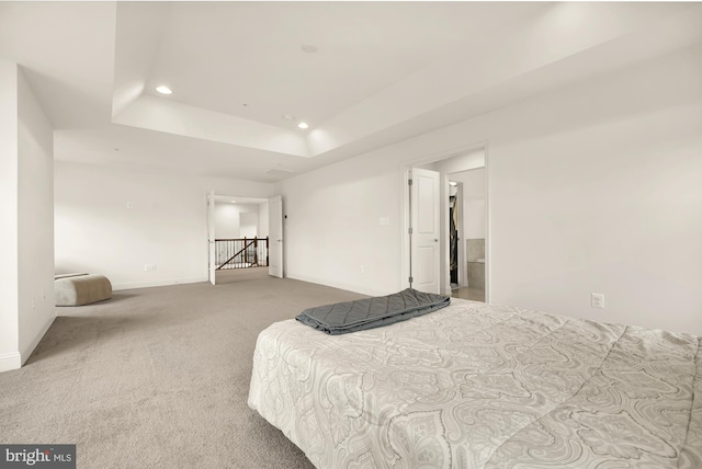 carpeted bedroom with baseboards, a tray ceiling, and recessed lighting