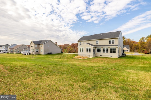 back of house with crawl space, a lawn, and central AC unit